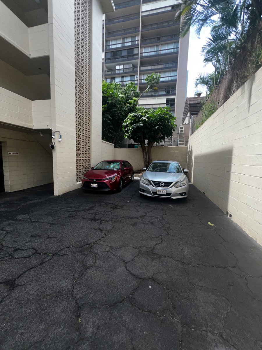 The silver car is in the assigned parking stall, note the stairwell to the left of the red car, where you would enter the building.