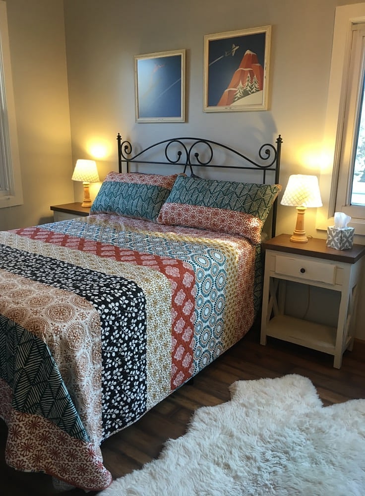 Queen bed on high frame, custom framed art and fine furnishings with linens provided.