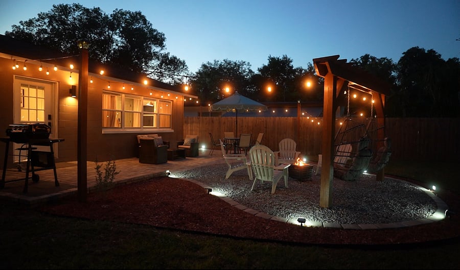 Imagine a tranquil backyard sanctuary adorned with gentle cafe lighting, creating an inviting ambiance perfect for unwinding or hosting gatherings.
