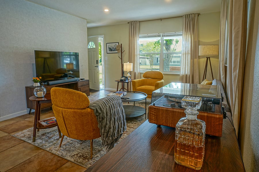 Indulge in a cocktail, groove to music on the turntable, and dive into your favorite book, all within the cozy ambiance of mid-century modern style.