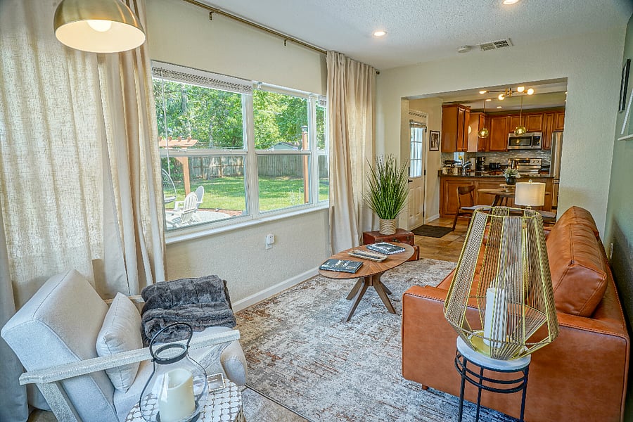 Enjoy the tranquility of the rear living room, flooded with sunlight and overlooking the backyard amenities.