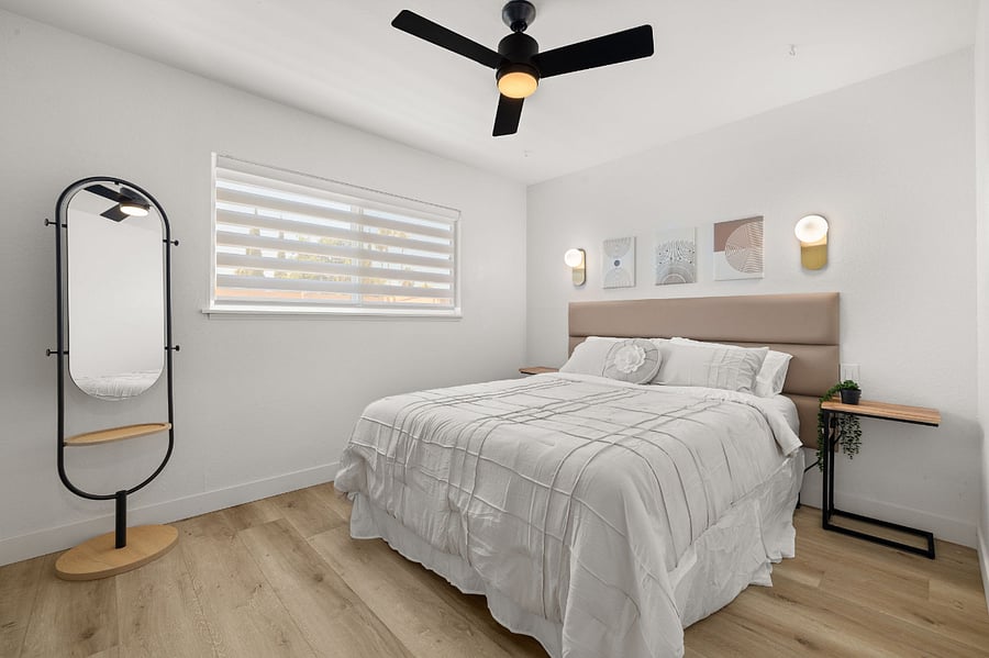 Modern elegant guest bedroom w/ Queen Bed and USB ports on nightstands.
