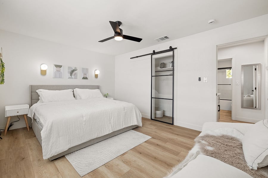 Modern elegant master bedroom w/ King Bed and USB ports on nightstands.