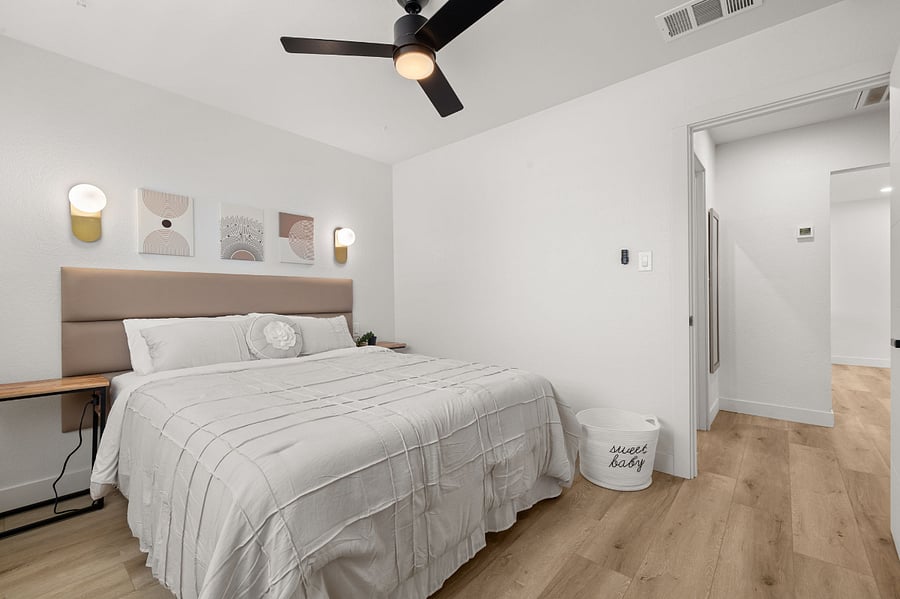 Modern elegant guest bedroom w/ Queen Bed and USB ports on nightstands.