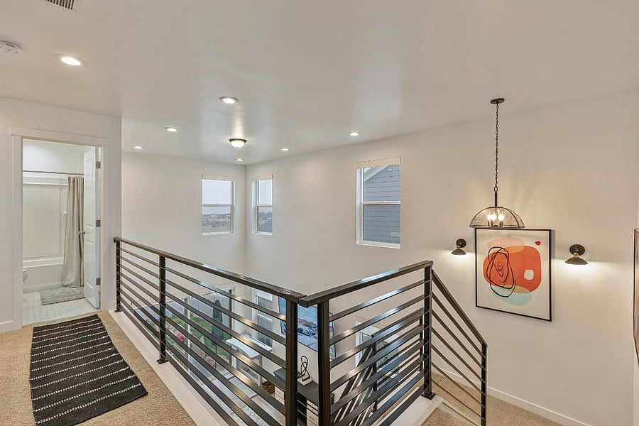Open below to the living room with remote-controlled shades. 