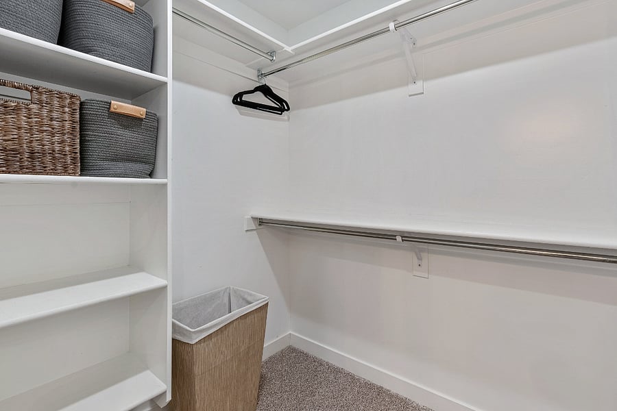 Bedroom #2 (Master) - Walk-in closet with storage baskets and hangers. 
