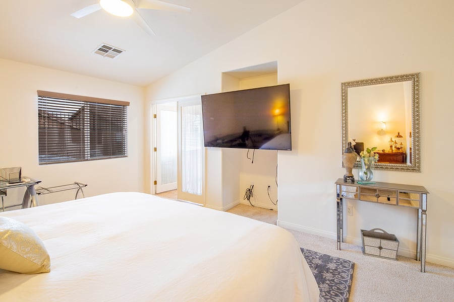 Large King bed in the primary bedroom with large flat screen TV