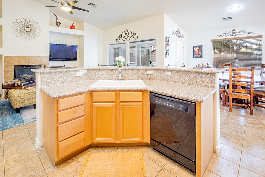 Kitchen view to the living room double sink with dishwasher