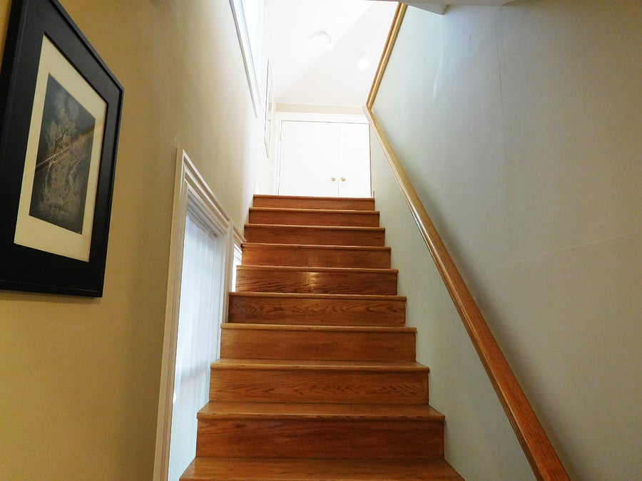 Stair going up to main floor. Stairwell is lighted at top and bottom.