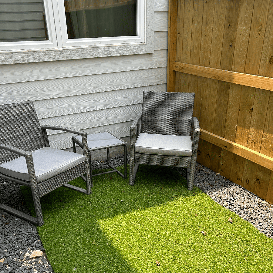 Small patio just off the kitchen with cozy seating for 2 and BBQ grill