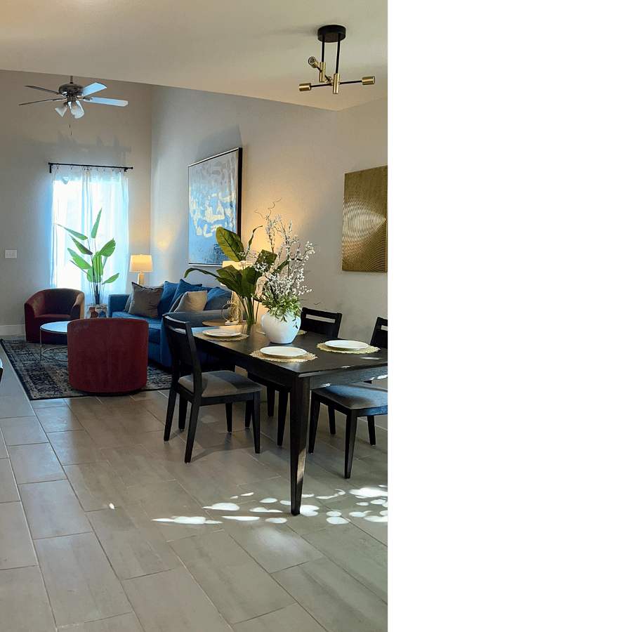 The first floor features a comfortable living room with seating/TV area. Dining table for 4.