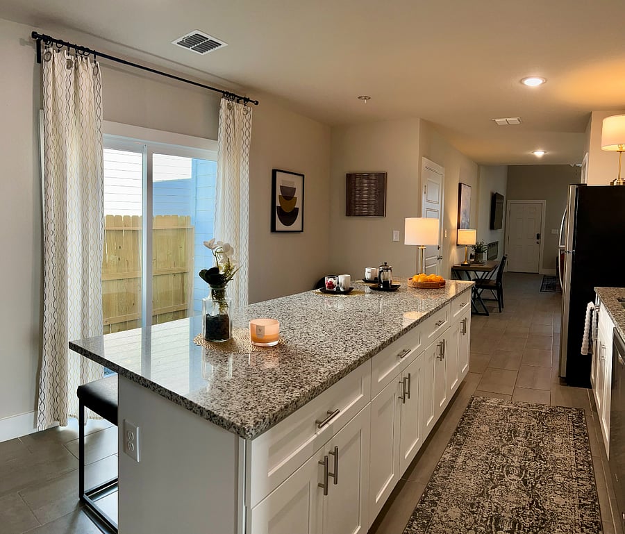 Kitchen features a spacious open-eating style island that is open to the enclosed patio. BBQ Grill is provided as a courtesy.