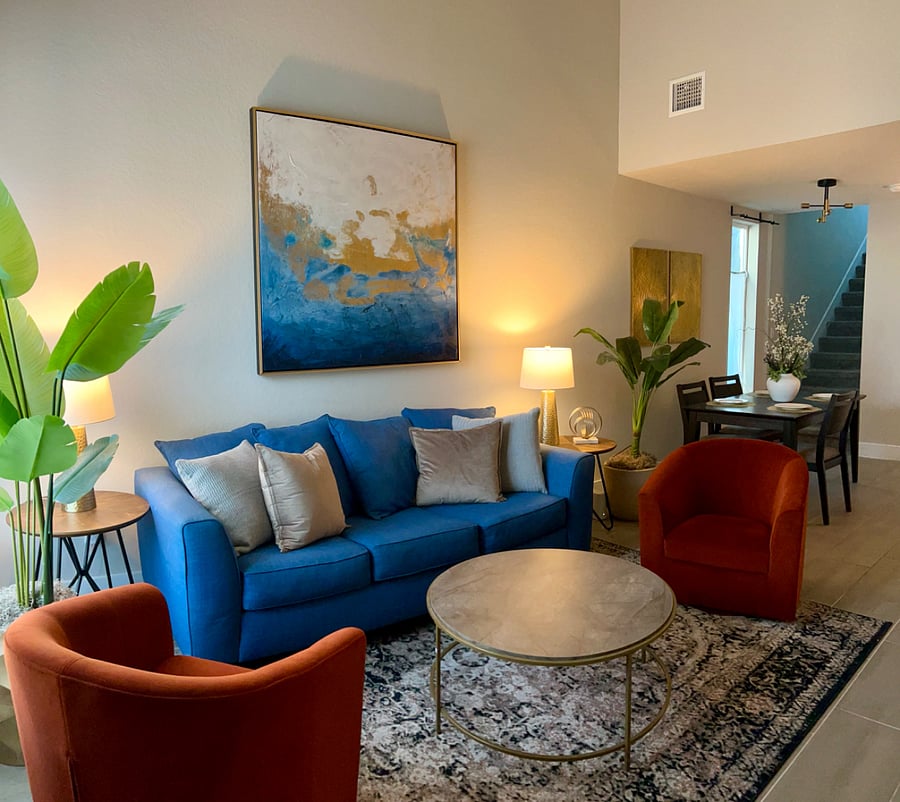 Main living room with 65" Smart TV and comfortable seating area with swivel barrel chairs