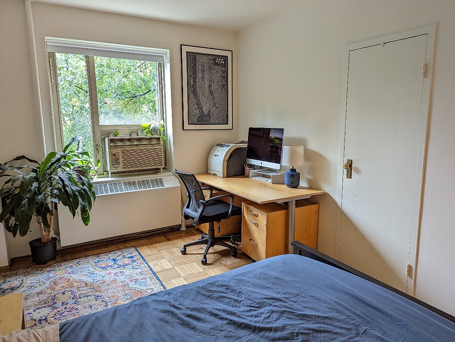 your room with large desk and window