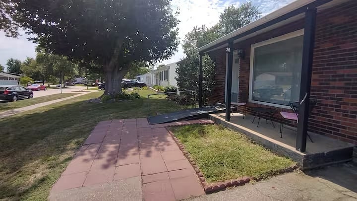 Front entry ramp and paved approach, shown from the side.
