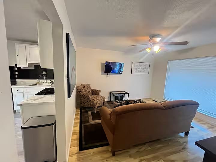 Living room viewed from the kitchen and dining area.
