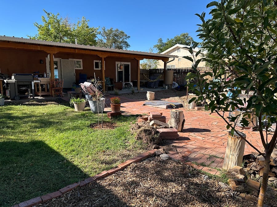 Gas grill, chopping block, couch, table chairs... Built for cooking and relaxing in the shade.