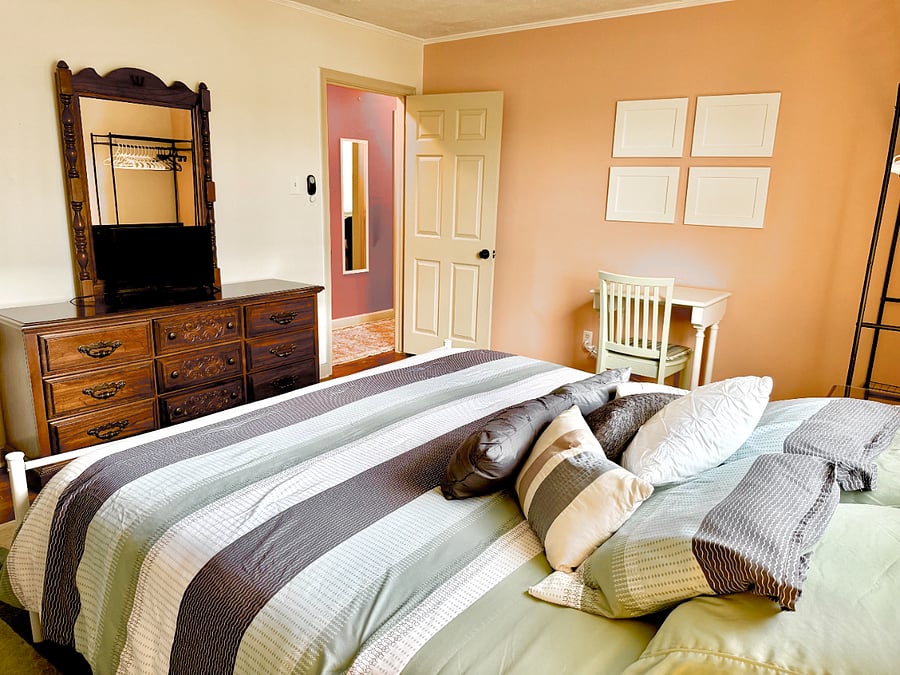 King bed with king dresser, small desk, flat tv monitor