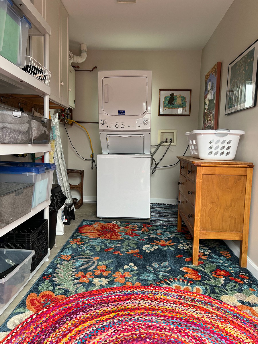Laundry room with extra space for storage. It's stocked with beach chairs, boogie boards, and sand toys. 