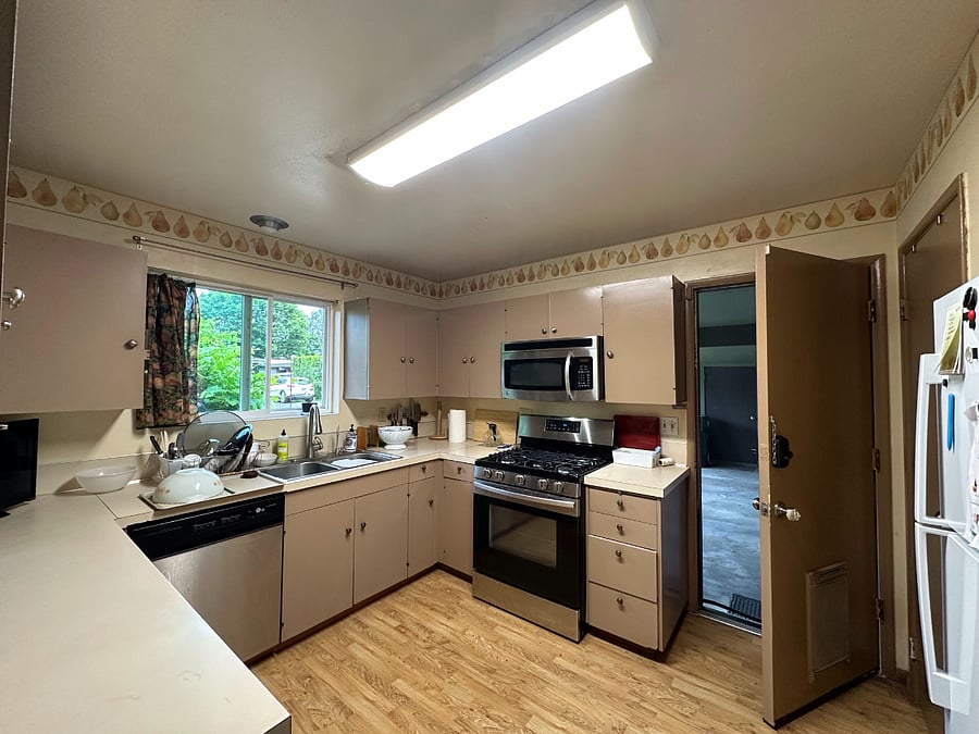 door on the right of kitchen opens into the carport