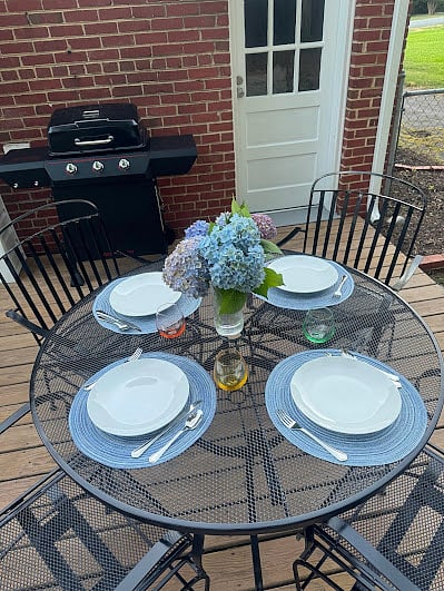 Step out onto the back deck where you'll find a gas grill and wrought iron table and chairs adorn the wooden deck to enjoy outdoor meals.