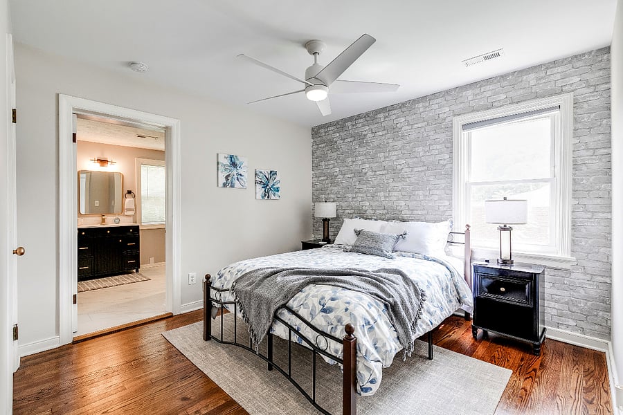 Owner's Suite Bedroom with comfortable Queen size bed, 2-way lamps with USB ports and a closet for hanging clothes.