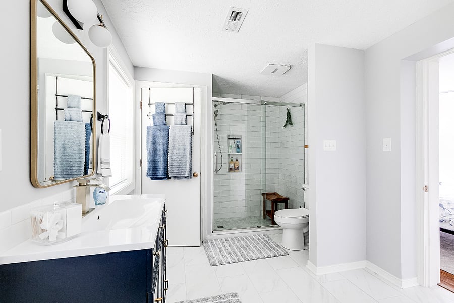 This spacious, newly renovated walk-in shower has places for your shampoo, conditioner,  and a teak wood bench,etc.