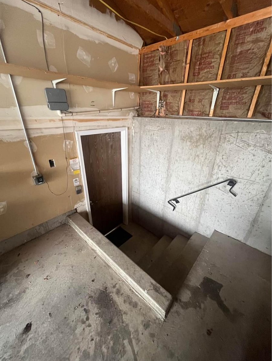 Seperate entrance through garage with storage area on shelves above and next to door.