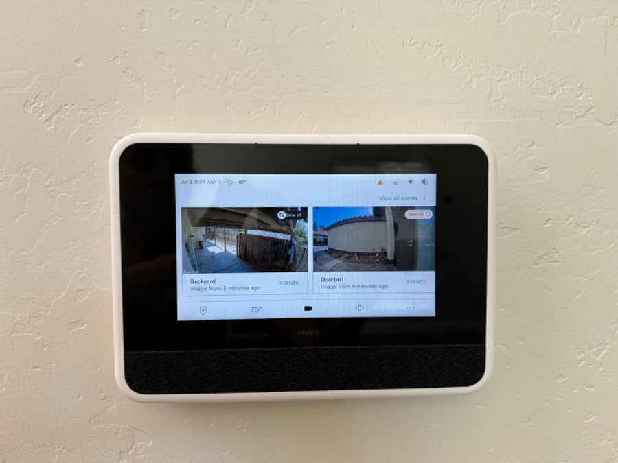 Security panel with live footage, rear camera, front door camera, and garage camera
