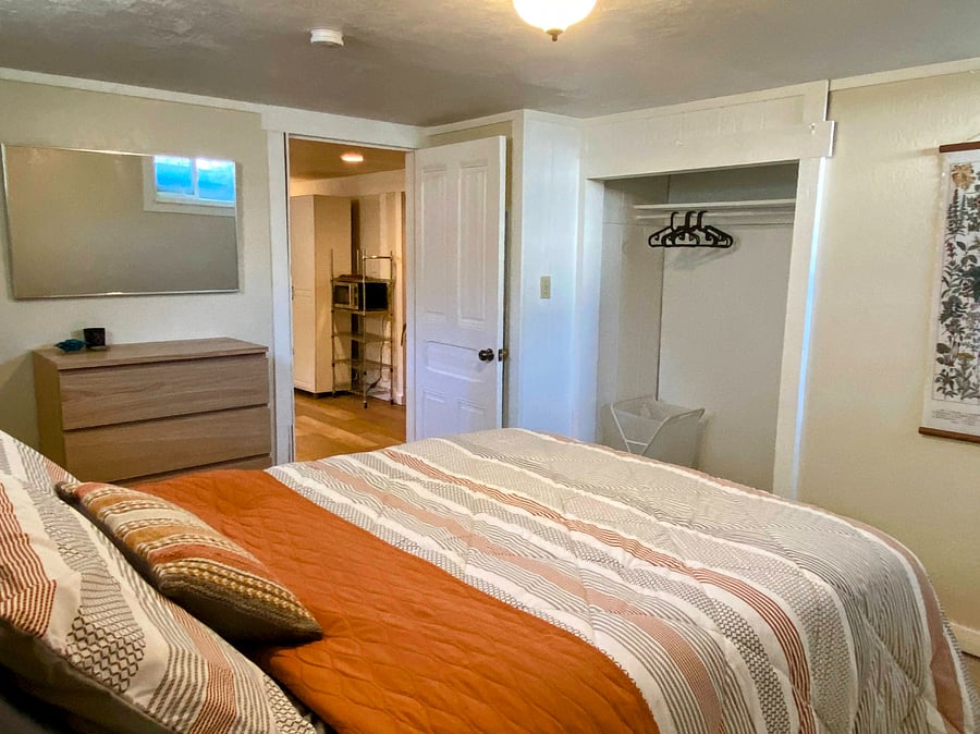 Bedroom with pillow top mattress, full sized closet, and dresser