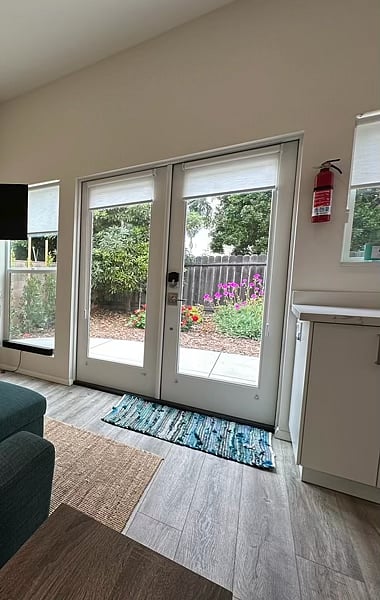 Living area looks out to the spacious landscaped patio