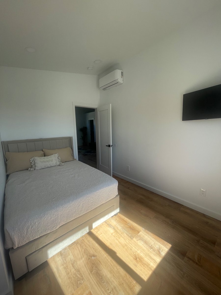 Bedroom 3 includes black out shades, 32 in mounted smart TV, and private closet