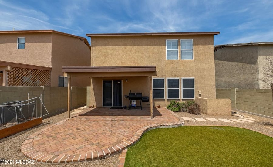 Back of home *not pictured: patio furniture (table and chairs) and natural gas grill, charcoal grill not included*