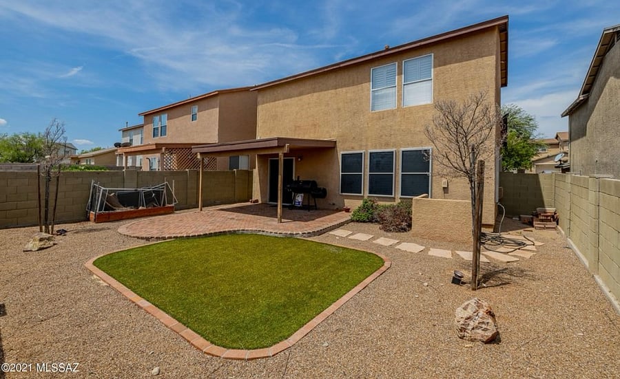 Back of home *not pictured: patio furniture (table and chairs) and natural gas grill, charcoal grill not included*