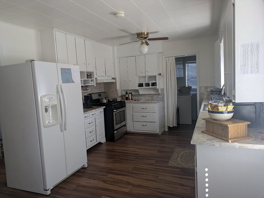 view from the dining area, coffee bar to the left, door to laundry room