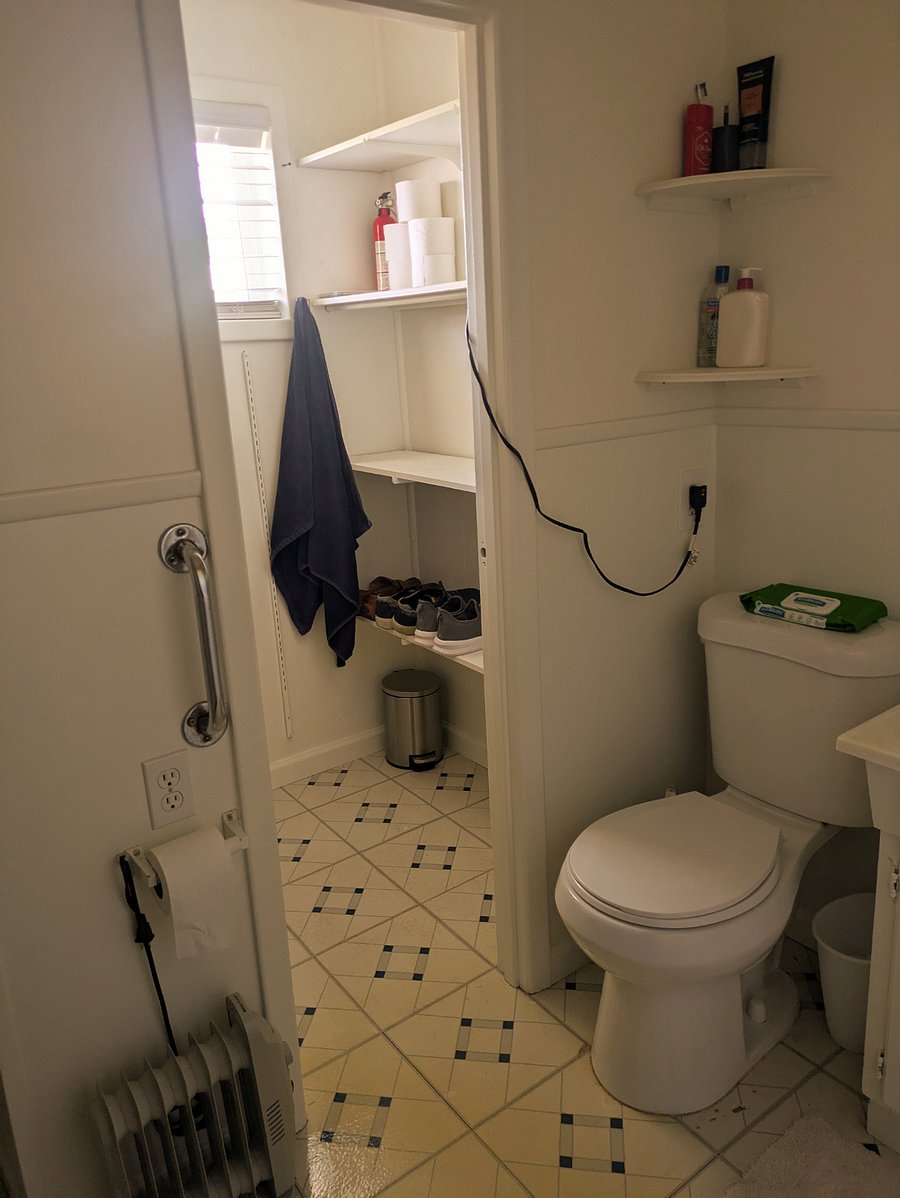 Bathroom at end of hall with its own closet