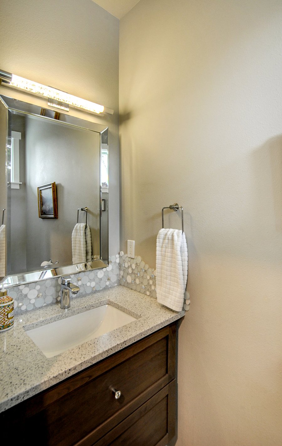 Main floor powder room with tall vanity and comfort height toilet.