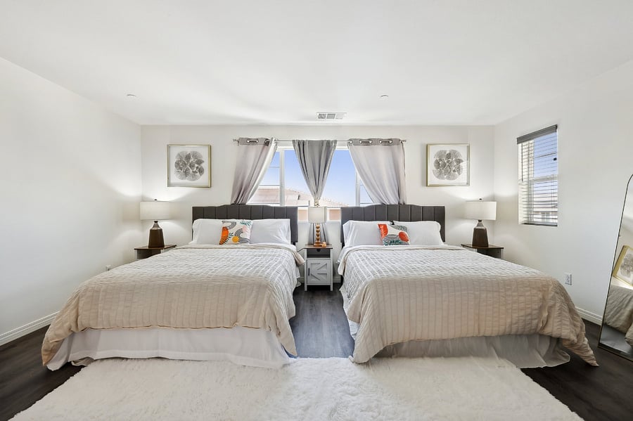 Double the comfort! This spacious bedroom with two queen-size beds is perfect for a restful getaway.