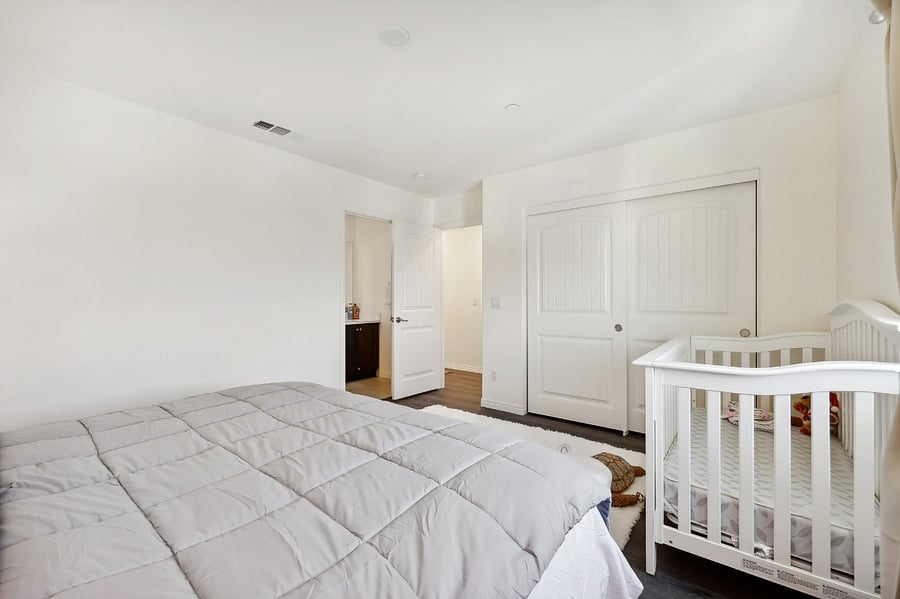 The standard-sized baby crib is equipped with safe, child-friendly toys.
