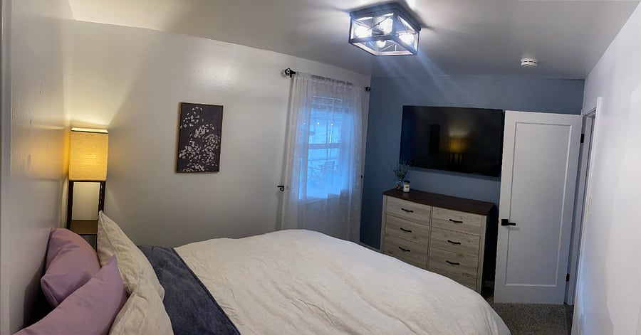 Bedroom 1 - queen bed, dresser, and TV