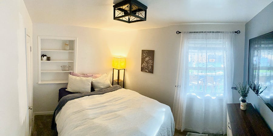Bedroom 1- queen bed, dresser, and TV