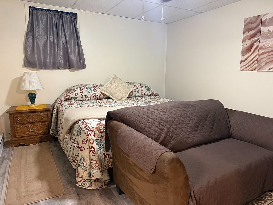 King-sized bed, love seat (for two), nightstand with lamp. 