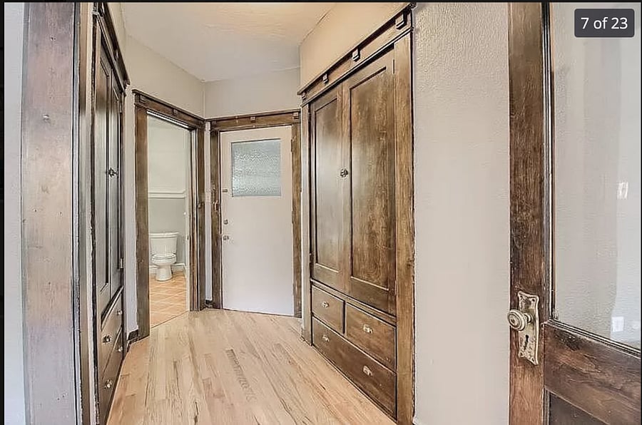 Main hallway, view from the private office looking at front door and bathroom.