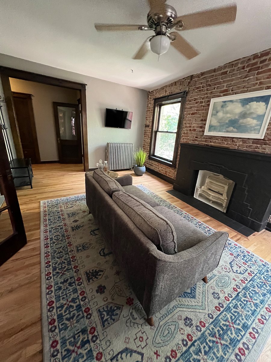 Cozy living room view from the historic marble dining booth. Non-working fireplace and views of the private backyard.