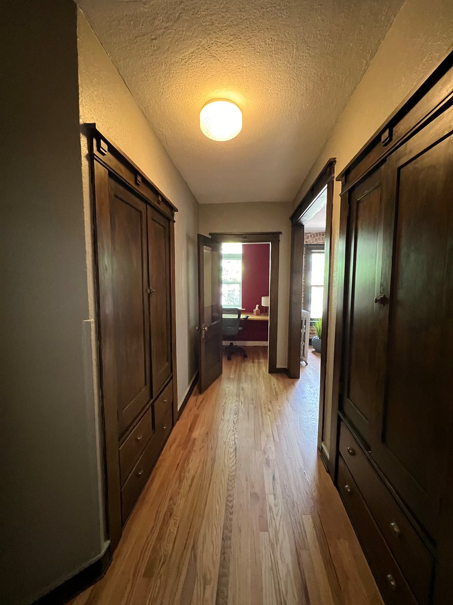 Main hallway view from the front door. Two full size closets with shelving and hanging space plus drawers for additional storage.