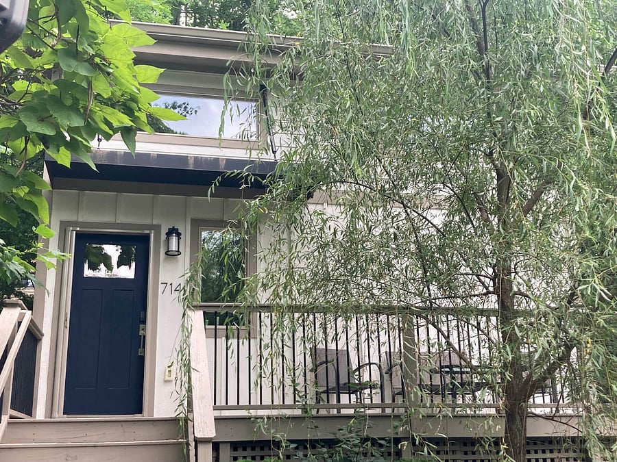 Tall willow tree shades the front deck