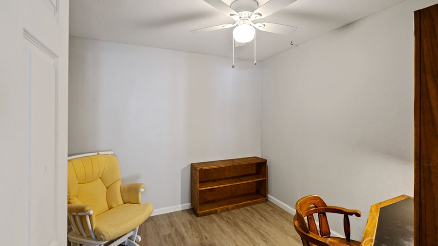 Separate office space with desk, book shelves, and rocking chair