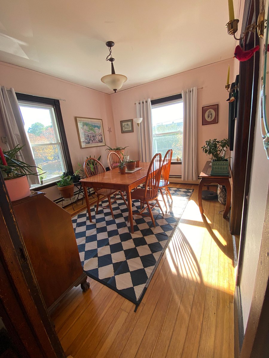 Shared dining room with plants on plants. Great for working in the day, eating (obv), and puzzling. That table can grow two times its size for big ol dinner parties too.