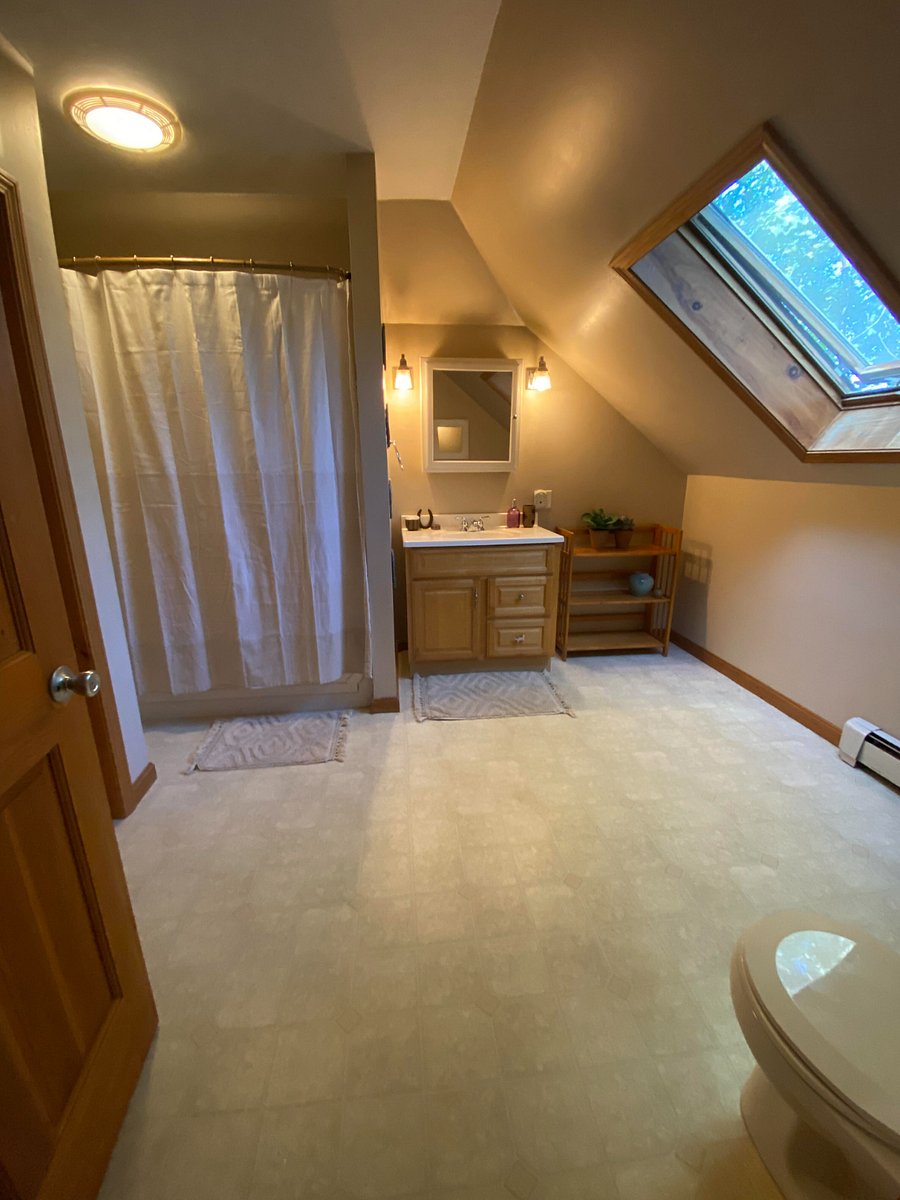 Large tub, vanity, and shelving for bathroom toiletries. Large bath towels, hand towels, and wash clothes included.