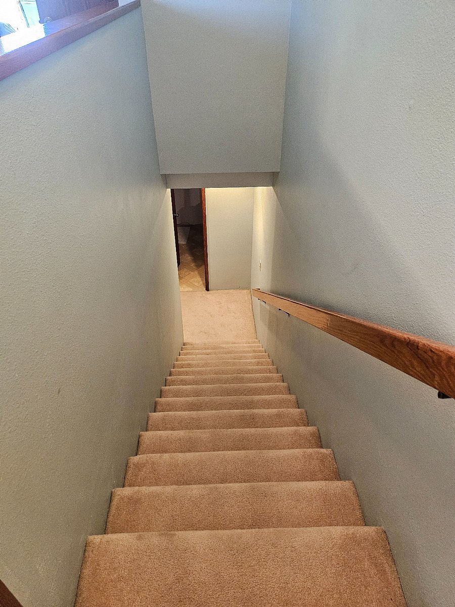 Stairs leading to bedrooms and full bath.